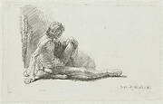 Nude man seated on the ground with one leg extended