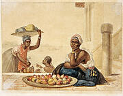 Tattooed black woman selling cashew fruits